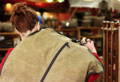 woman with a rollup garment cover hanging over her shoulder walking through the frost river shop